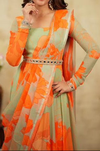 Woman wearing an orange and green traditional outfit with a beige background
