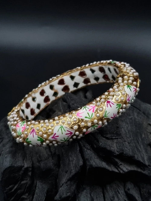 Saffron Silk Aiva Jewel featuring intricate design and vibrant colors, displayed on a neutral background.